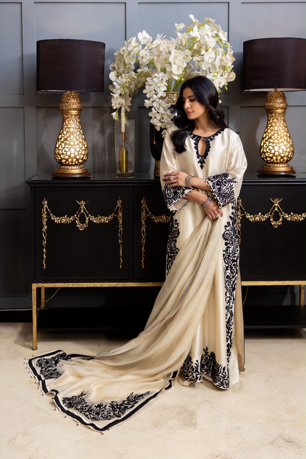 Model in Eclipse, an ivory butter silk shirt with black embroidery and a trailing organza dupatta